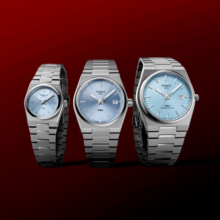 Three different sizes of Tissot PRX, in 40, 35 and 25 mm, on a Tissot red background